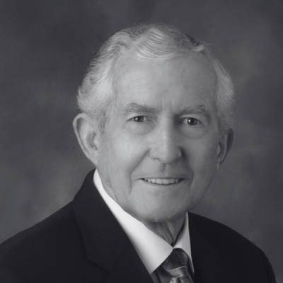 Black-and-white portrait of Paul J. Meyer wearing a suit and tie, smiling slightly at the camera.