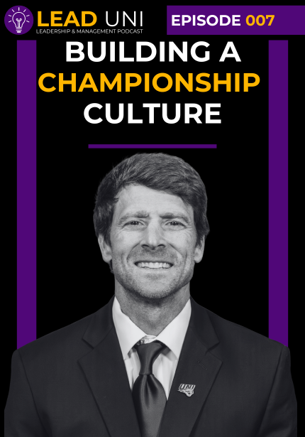 Podcast episode cover for the LEAD UNI Leadership & Management Podcast with a black background and purple and gold branding. A banner at the top reads “Episode 006.” Large bold text in the center reads “Building a Championship Culture,” with the word “Championship” highlighted in gold. Below the title, the text reads “with Todd Stepsis.” The lower portion features a black-and-white headshot of a person wearing a suit jacket, dress shirt, and tie. Purple vertical bars frame the left and right sides of the co